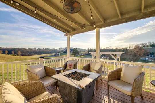 The Milkbarn porch at golden hour, the after-party and overnight space for a wedding party at Cedar Pond Farms