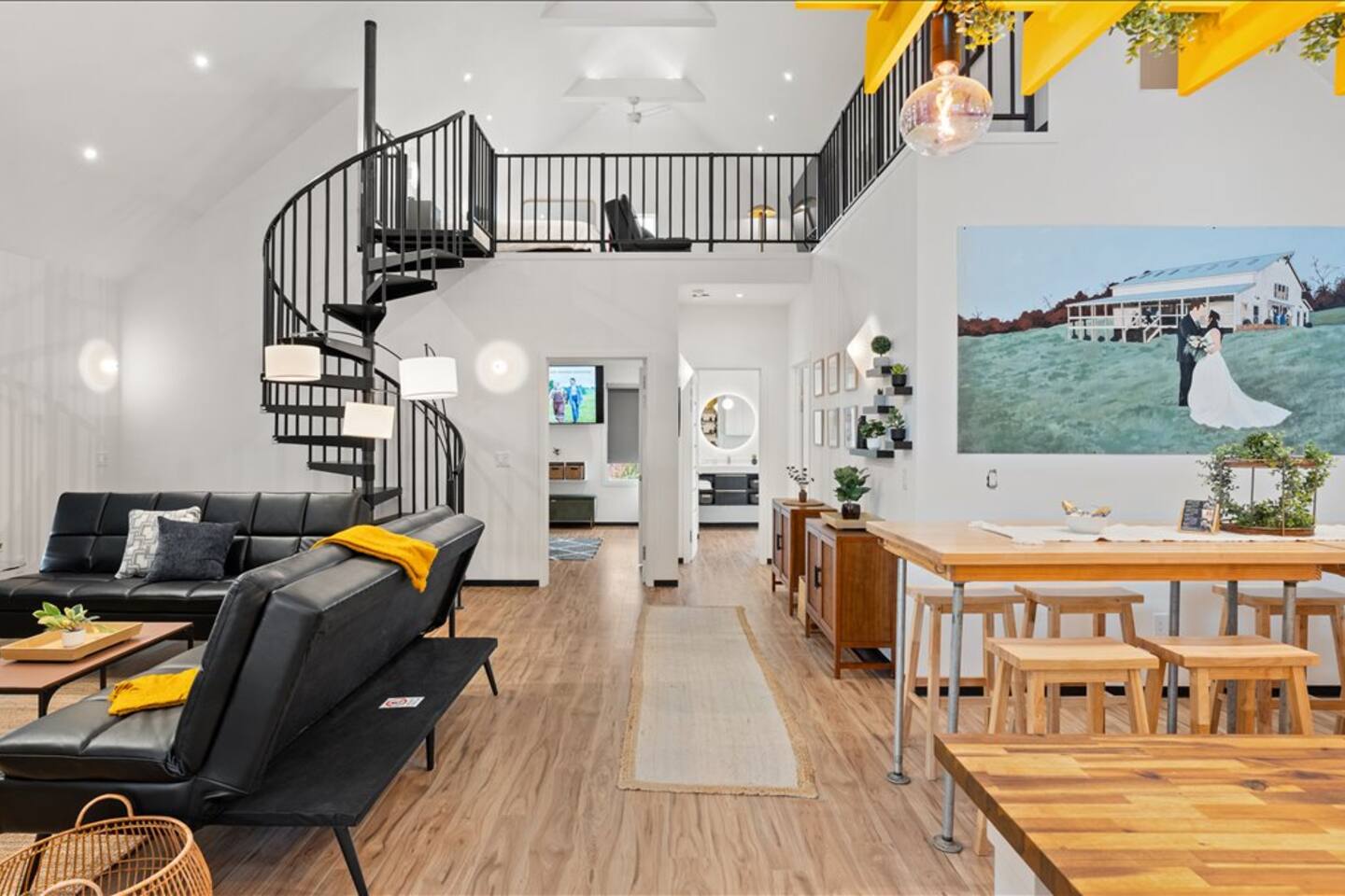 Bright open loft with spiral staircase and stylish modern gathering space